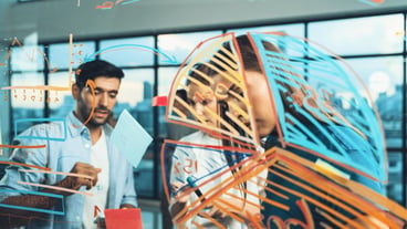 Smart business team working together brainstorming idea at glass wall tracery