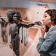 July 22, 2022 Neanderthal Museum Germany Detailed wax figure of prehistoric caveman Neanderthal with spear in the museum Human Sapiens anthropology science and theory of evolution