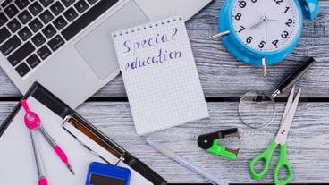 Special education concept. Flat lay items for studying and learning on a white wooden table.