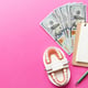 Flat lay composition with an educational dental typodont model and money with a notebook on a colored tabletop view. Expensive treatment.