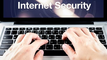 Handwriting on a laptop with internet security on the screen with a blurred background. Internet security concept.