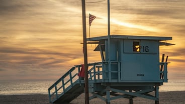 Lifeguard hut at beach during sunset