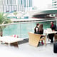 Group of positive stylish business people having a conversation at cafe terrace.