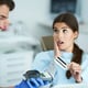 Adult woman paying for visit in dentist office