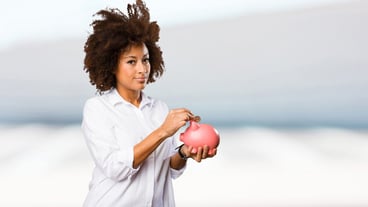 young black woman holding a piggy bank
