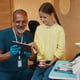 Smiling Dentist Showing Procedure On Tablet Screen