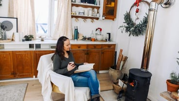 Young woman sitting on sofa at home