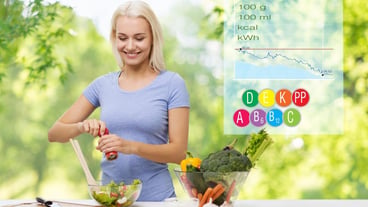 Smiling woman cooking vegetable salad