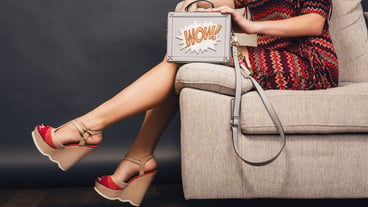 Woman posing with stylish footwear summer fashion and bag
