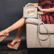 Woman posing with stylish footwear summer fashion and bag