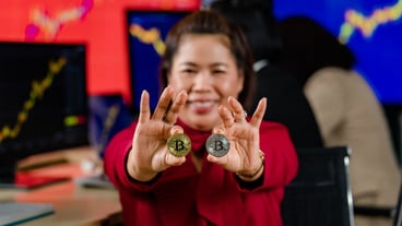 Closeup shot of golden bitcoin electronic token cryptocurrency money in businesswoman investor