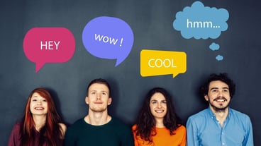 Smiling group of diverse businesspeople working together around a meeting table in an office complex lobby
