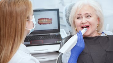 Elderly woman getting dental 3d scanning by her dentist