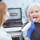 Elderly woman getting dental 3d scanning by her dentist