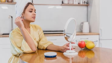 Woman in the mirror of the bathroom making a makeup The natural beauty of a woman