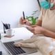 Women work in the house with their pets. concept of working from home and social distance
