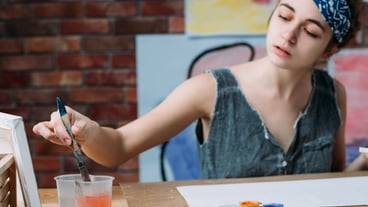 Female artist painting in creative workspace