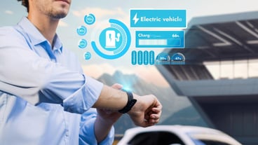 Entrepreneur checks EV car battery status on smartwatch hologram while charging charging station with modern construction background Futuristic lifestyle of clean energy for EV technology adaptation Peruse