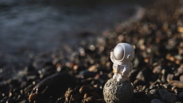 astronaut figurine standing on the ground