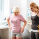 Practicing sport. Good looking fit woman holding a rubber band while speaking about new exercise with her patient