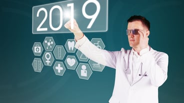 Digital composite image of doctor touching number 2019 against a blue background