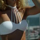 Midsection of beautiful woman wearing white bikini top