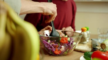 Midsection of man holding fruits in bowl at home