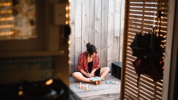 Girl painting sitting on the floor behind the door