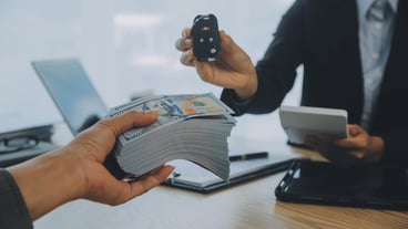 Salesman send key to customer after good deal agreement successful car loan contract buying or selling new vehicle