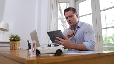 Stressed and frustrated car design engineer put his head in his hand synchronos