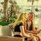 Mother and daughter communicate on a smartphone in a cafe communication and family leisure