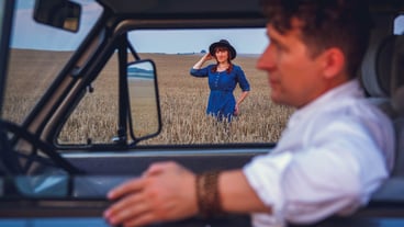 Portrait of woman walking through wheat field against sky background and portrait of man driving car