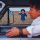 Portrait of woman walking through wheat field against sky background and portrait of man driving car