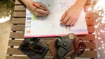 A person who writes on a map photo