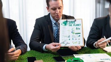 A diverse group of business people plan business marketing with environmental responsibility for a greener ecology. Productive teamwork contributes to the preservation of nature and a sustainable future