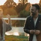 Couple enjoying golden hour light next to lake in park