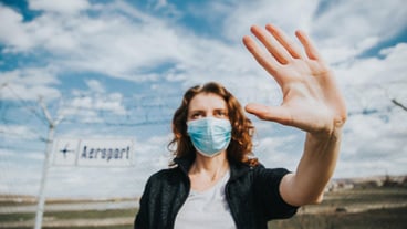 Portrait of young woman standing against sky