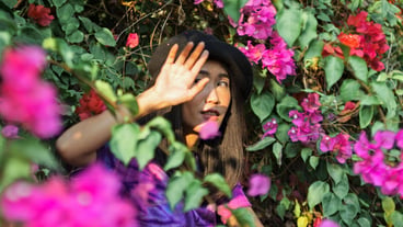 Portrait of woman with pink flowers