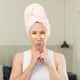 with mouth and eyes wide open and hand on chin beauty treatment concept
