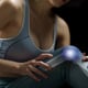 Woman holds her hands to the knee, pain in the knee highlighted in blue, medicine, massage concept.