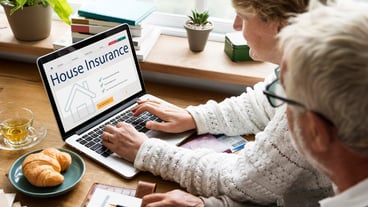 Senior couple consulting house insurance on the laptop