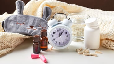 Sleeping mask alarm clock earplugs and pills healthy night sleep creative concept
