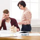 Two colleagues discussing architectural project, working with blueprints in modern workplace interior, copy space