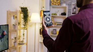 Using a smart light app to turn on the light bulbs in the house. Close up slow motion footage