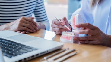 Midsection of couple holding hands on table