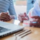 Midsection of couple holding hands on table