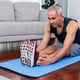 Active and fit senior man warmup and stretching before home exercising routine at living room while watching online fitness video Healthy lifestyle concept after retirement for pensioner Clout