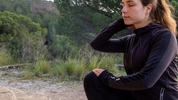 Beautiful white Caucasian girl stretching before workout outdoors in nature healthy lifestyle