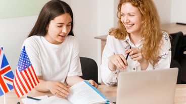 Foreign school private study, smile, laught with a school girl. Teacher explain grammar of native language using laptop
