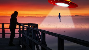a person is watching a spaceship with a man in a red ring on the left